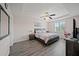 Spacious main bedroom with trey ceiling, wood-look floors, and ample natural light at 5793 Dornich Dr, Auburndale, FL 33823