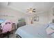 Bright main bedroom featuring wood-look floors, a ceiling fan, and a desk area at 5793 Dornich Dr, Auburndale, FL 33823