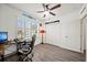 Comfortable home office with hardwood floors, a ceiling fan, and a large window at 5793 Dornich Dr, Auburndale, FL 33823