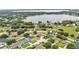 Aerial view capturing a lakeside community with lush trees and well-spaced homes at 601 Pintail Cir, Auburndale, FL 33823