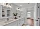Spacious bathroom featuring double sinks and an open doorway at 601 Pintail Cir, Auburndale, FL 33823