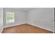 Well-lit bedroom with window, wood-look flooring and a closet at 601 Pintail Cir, Auburndale, FL 33823