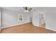Spacious bedroom features a ceiling fan, natural light and a doorway to an adjacent hallway at 601 Pintail Cir, Auburndale, FL 33823
