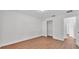 Bedroom featuring hard surface floors, closet, and a doorway to an adjacent hallway at 601 Pintail Cir, Auburndale, FL 33823