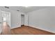 Bedroom with walk-in closet, hard surface floors and a view into the hallway at 601 Pintail Cir, Auburndale, FL 33823