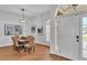 Inviting dining area featuring a table with six chairs, modern lighting, and elegant decor at 601 Pintail Cir, Auburndale, FL 33823