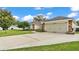 Charming exterior features a two-car garage and well-maintained landscaping at 601 Pintail Cir, Auburndale, FL 33823