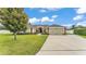 Well-manicured lawn and mature trees complement this lovely home's exterior at 601 Pintail Cir, Auburndale, FL 33823