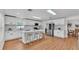 Spacious kitchen with white cabinetry, stainless appliances, and breakfast bar at 601 Pintail Cir, Auburndale, FL 33823
