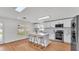Open kitchen with white cabinetry, stainless appliances, and breakfast bar seating at 601 Pintail Cir, Auburndale, FL 33823