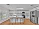 Bright eat-in kitchen with stainless steel appliances and modern white cabinets at 601 Pintail Cir, Auburndale, FL 33823