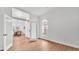 Bright living room boasts light wood floors and a unique transom window above the doorway at 601 Pintail Cir, Auburndale, FL 33823