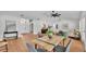 Spacious living room features wood floors, a large dining room table, and easy access to the kitchen at 601 Pintail Cir, Auburndale, FL 33823
