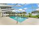 Screened pool featuring a clean and serene pool with a white patio and fence at 601 Pintail Cir, Auburndale, FL 33823