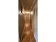 A long, narrow hallway with wooden floors, doors, and framed art at 629 W Williams St, Lakeland, FL 33805