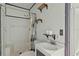 Bathroom with tub/shower, sink, toilet, open shelving and blue trim at 633 Glenda St, Lakeland, FL 33805