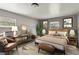 Cozy bedroom featuring a queen bed, stylish decor, and a sitting area for relaxing and enjoying natural light at 633 Glenda St, Lakeland, FL 33805