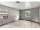 Neutral bedroom with tile flooring, two windows, and an A/C unit at 633 Glenda St, Lakeland, FL 33805