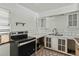 The kitchen features an electric range, updated floors, and white cabinets at 633 Glenda St, Lakeland, FL 33805