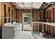 Rustic laundry room with an exterior door, washer, and dryer in need of TLC or renovation at 633 Glenda St, Lakeland, FL 33805