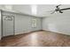 Living room has faux wood floors, ceiling fan, and a window at 633 Glenda St, Lakeland, FL 33805