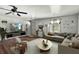 Inviting living room featuring a comfortable sectional sofa, modern decor, and a large window overlooking the yard at 633 Glenda St, Lakeland, FL 33805