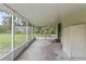 Spacious screened-in porch with views of the backyard and surrounding greenery at 633 Glenda St, Lakeland, FL 33805