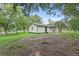 Quaint single-story home with green trim, a fenced yard, and mature trees at 633 Glenda St, Lakeland, FL 33805