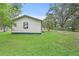 Side view of a cozy home featuring green trim and a lush green lawn at 633 Glenda St, Lakeland, FL 33805