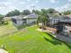 Spacious backyard featuring a large lawn, screened-in pool, and patio with plenty of room to relax and entertain at 6357 Ashley Dr, Lakeland, FL 33813