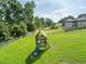 Large grassy backyard includes a playset with a slide, perfect for outdoor fun and recreation at 6357 Ashley Dr, Lakeland, FL 33813