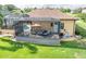Backyard showcasing a screened lanai with ample seating, an outdoor kitchen, and a view of the lush landscaping at 6357 Ashley Dr, Lakeland, FL 33813