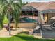 Pool and patio surrounded by mature palm trees, creating a private and luxurious backyard retreat at 6357 Ashley Dr, Lakeland, FL 33813