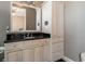 Bathroom featuring a black granite countertop, a white vanity, and a cabinet storage tower at 6357 Ashley Dr, Lakeland, FL 33813