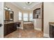 Primary bathroom with corner tub, vanity, and tiled floor at 6357 Ashley Dr, Lakeland, FL 33813