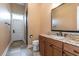 Well-lit bathroom with granite countertop vanity, wood cabinets and tiled floor for a modern, clean aesthetic at 6357 Ashley Dr, Lakeland, FL 33813