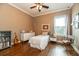 Cozy bedroom featuring hardwood floors, a ceiling fan, and a charming single bed near the window at 6357 Ashley Dr, Lakeland, FL 33813