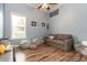 Bright bedroom with blue walls, hardwood floors, a cozy couch, and beanbag chairs, creating a relaxed atmosphere at 6357 Ashley Dr, Lakeland, FL 33813
