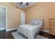 Neutral toned bedroom with wood floors, a plush bed, and soft lighting for a relaxing atmosphere at 6357 Ashley Dr, Lakeland, FL 33813