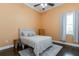 Simple bedroom showcasing wood floors, a soft rug, and a comfortable bed with neutral tones and plenty of light at 6357 Ashley Dr, Lakeland, FL 33813