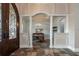 Formal dining room with elegant columns, wainscoting, and decorative lighting adjacent to the entry foyer at 6357 Ashley Dr, Lakeland, FL 33813