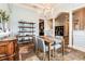 Elegant dining room features a chandelier, display shelves, wainscoting, and an ornate serving buffet at 6357 Ashley Dr, Lakeland, FL 33813