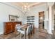 Dining room with view of buffet, chandelier, columns, tile floors and doorway to another room at 6357 Ashley Dr, Lakeland, FL 33813