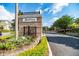 Elegant community entrance featuring a stone wall, manicured landscaping, and gated access at 6357 Ashley Dr, Lakeland, FL 33813