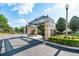 Community entrance with a decorative archway, stone pillars, and manicured landscaping at 6357 Ashley Dr, Lakeland, FL 33813
