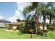 Well-manicured lawn and tropical landscaping enhances the curb appeal of this beautiful home at 6357 Ashley Dr, Lakeland, FL 33813
