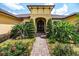 Lovely front entrance with elegant landscaping and a brick walkway that leads to the front door at 6357 Ashley Dr, Lakeland, FL 33813