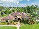 Stunning aerial view showcasing the home's manicured lawn, landscaping, and inviting curb appeal at 6357 Ashley Dr, Lakeland, FL 33813
