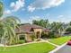 Beautifully landscaped front yard with mature trees and lush gardens framing this stunning home at 6357 Ashley Dr, Lakeland, FL 33813