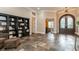 Open living room with tile flooring, built in bookcase, and arched doorframe at 6357 Ashley Dr, Lakeland, FL 33813